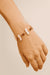Hand wearing a contemporary bracelet with irregular white pearl and brown stone beads