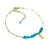 Gold chain bracelet with blue gemstone beads and rectangular charm, elegant jewelry.