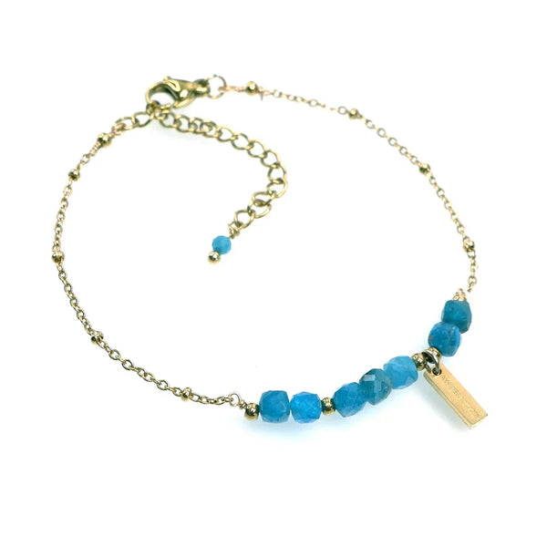 Gold chain bracelet with blue gemstone beads and rectangular charm, elegant jewelry.