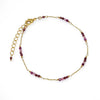 Delicate gold chain bracelet with small purple beads, adjustable clasp, elegant jewelry