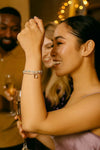 Woman wearing layered silver bracelets at a party, elegant jewelry for evening wear