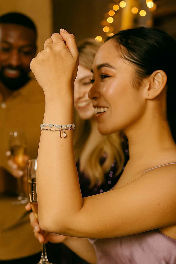 Woman wearing layered silver bracelets at a party, elegant jewelry for evening wear
