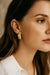 Gold hoop earring with pearl accents on woman, elegant Indian fusion jewelry style