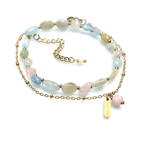 Gold chain necklace with pastel gemstone beads and adjustable extender, displayed on white background