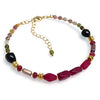 Gold chain bracelet with red, green, black, and gold gemstone beads, adjustable clasp